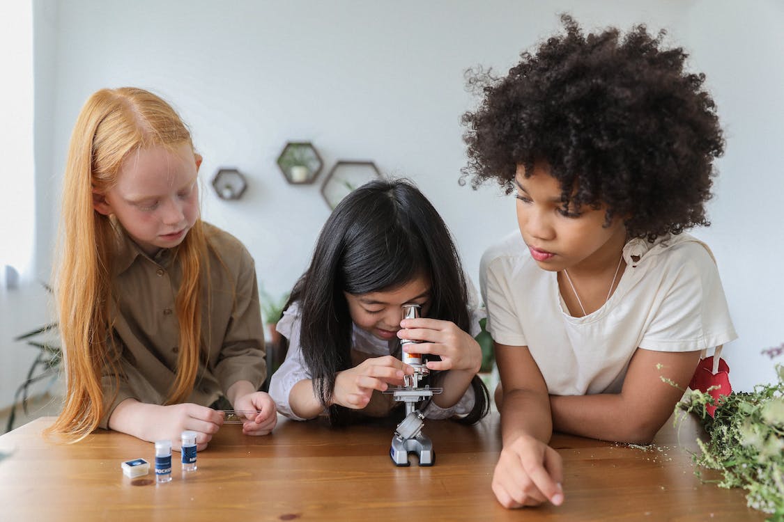 school children with microscope world water day