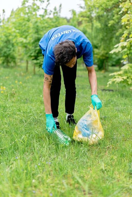 man cleaning litter in environment